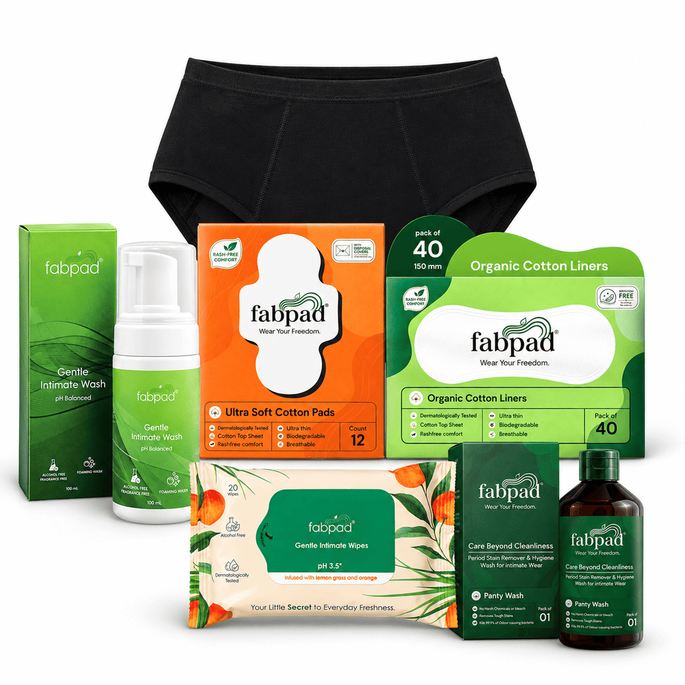 A Fabpad men's intimate care product bundle featuring black briefs, organic cotton liners, ultra soft pads, green intimate wash and wipes, a pump bottle, and a dark amber liquid wash, all arranged on a white background.