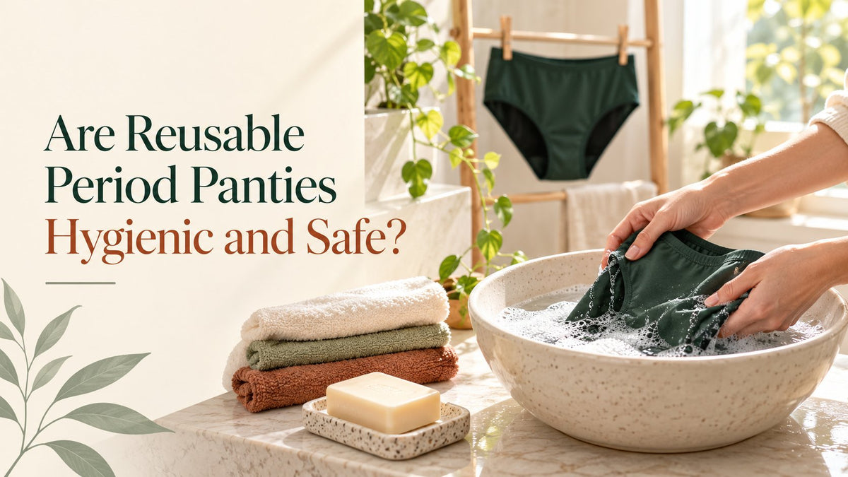Hands washing a green period panty in a basin of soapy water, with another pair drying on a rack